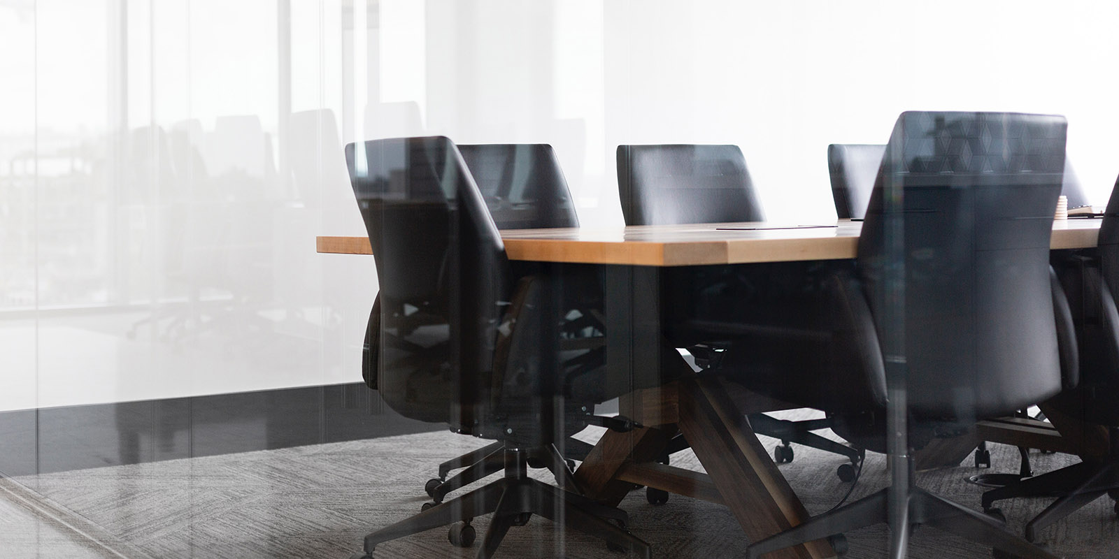 Black chairs around a boardroom table